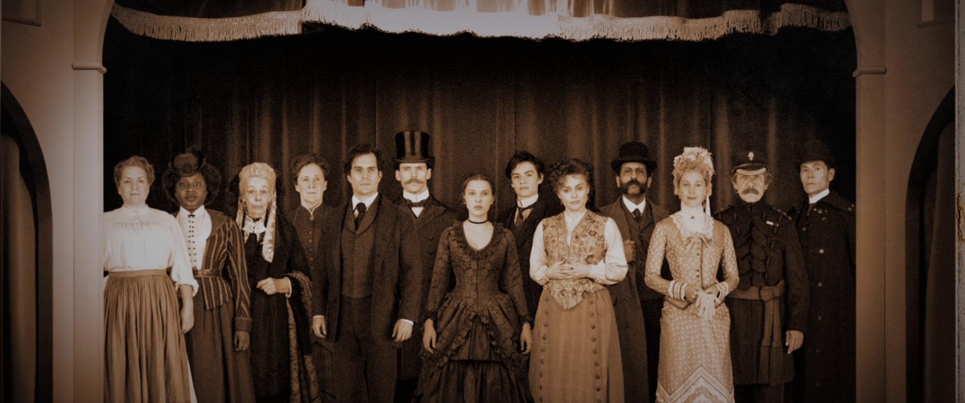 An aged photo of the films cast stood on a stage